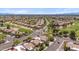 Aerial view showcasing a community with tile roofs, lush landscaping, golf course, and mountain views at 8405 W Utopia Rd, Peoria, AZ 85382