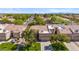 Aerial view of a neighborhood with tree-lined streets and manicured lawns near a golf course at 8405 W Utopia Rd, Peoria, AZ 85382