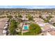 Aerial shot of homes with tile roofs surrounding community pool, set against mountain backdrop at 8405 W Utopia Rd, Peoria, AZ 85382