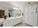 Large bathroom with bright white cabinets, dual sinks and a large mirror at 8405 W Utopia Rd, Peoria, AZ 85382