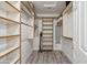 Spacious walk-in closet with lots of shelving for organized storage at 8405 W Utopia Rd, Peoria, AZ 85382