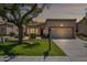 Inviting single-story home featuring a well-manicured lawn and a convenient two-car garage at 8405 W Utopia Rd, Peoria, AZ 85382