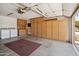 Spacious garage featuring built-in storage cabinets and a convenient laundry area with a washer and dryer at 8405 W Utopia Rd, Peoria, AZ 85382