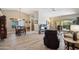 Bright living space with an open floor plan connecting the dining area and a patio at 8405 W Utopia Rd, Peoria, AZ 85382