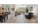Open-concept living room with a kitchen view, patio access, and comfortable seating at 8405 W Utopia Rd, Peoria, AZ 85382