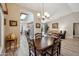 Open concept living and dining area with vaulted ceilings, neutral colors and wood-look floors at 8405 W Utopia Rd, Peoria, AZ 85382