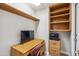 Office with a wooden desk, built-in shelves, and a comfortable chair for a productive workspace at 8405 W Utopia Rd, Peoria, AZ 85382