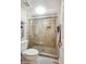 Bathroom with a tile shower and glass doors, next to the toilet at 8405 W Utopia Rd, Peoria, AZ 85382