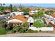 Tile roof home with mature landscaping, pool, white privacy walls, and mountain views at 8719 E San Marcos Dr, Scottsdale, AZ 85258