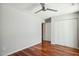 A bedroom with wood floors, closet, and neutral walls at 8719 E San Marcos Dr, Scottsdale, AZ 85258