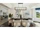 Formal dining room with stylish modern lighting, seating, and decor at 8719 E San Marcos Dr, Scottsdale, AZ 85258