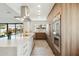 Sleek kitchen with modern appliances, an eat-in island, and hardwood cabinetry at 8719 E San Marcos Dr, Scottsdale, AZ 85258