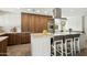 Modern kitchen featuring a large island, stainless steel appliances, and custom wood cabinetry at 8719 E San Marcos Dr, Scottsdale, AZ 85258