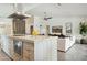 Open-concept kitchen with large island flows into the living room, creating a seamless living space at 8719 E San Marcos Dr, Scottsdale, AZ 85258