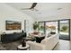 Bright living room with modern decor, sleek furniture, and a view of the pool area at 8719 E San Marcos Dr, Scottsdale, AZ 85258