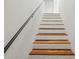 A contemporary stairway with wooden treads and a decorative white-tiled wall at 8719 E San Marcos Dr, Scottsdale, AZ 85258