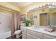 Bright bathroom with a large mirror, white vanity, and combination shower and tub at 9019 N 87Th Way, Scottsdale, AZ 85258