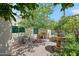 Charming courtyard with brick pavers, a stone fountain, mature shade tree, and patio set at 9019 N 87Th Way, Scottsdale, AZ 85258