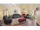 Well-lit living room showcasing wood floors, a brick fireplace, and neutral-toned decor at 9019 N 87Th Way, Scottsdale, AZ 85258