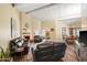 Bright living room with a fireplace, tan walls, wood floors, and two leather couches at 9019 N 87Th Way, Scottsdale, AZ 85258