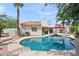 Backyard with a pool, well maintained lawn, patio furniture, and lush landscaping at 9019 N 87Th Way, Scottsdale, AZ 85258