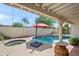 Backyard featuring in-ground pool, hot tub, and umbrella covered table and chairs at 9019 N 87Th Way, Scottsdale, AZ 85258