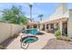 Backyard pool and spa with red umbrella and lush landscaping at 9019 N 87Th Way, Scottsdale, AZ 85258