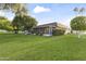 Expansive backyard with lush green lawn and mature landscaping provides a private outdoor retreat at 9202 N 107Th Ave, Sun City, AZ 85351