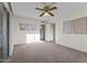Large primary bedroom with neutral carpet, ceiling fan, and artwork, offering ample space at 9202 N 107Th Ave, Sun City, AZ 85351