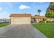Charming single-story home featuring a well-manicured lawn and a spacious two-car garage at 9202 N 107Th Ave, Sun City, AZ 85351