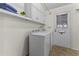 Bright laundry room features a washer, dryer, storage cabinets, and convenient access to the outdoors at 9202 N 107Th Ave, Sun City, AZ 85351