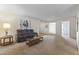 Comfortable living room with a plush leather sofa, side table, and coffee table on neutral carpeting at 9202 N 107Th Ave, Sun City, AZ 85351