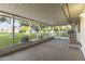 Enclosed patio featuring an outdoor seating area and picturesque views of the green landscape at 9202 N 107Th Ave, Sun City, AZ 85351