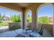 Covered outdoor patio with seating area and views of the surrounding greenery at 10655 N 9Th St # 115, Phoenix, AZ 85020