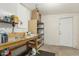 Unfinished basement includes storage shelves, work bench, and access door at 1240 E Indigo St, Mesa, AZ 85203
