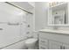 Bright bathroom with a modern shower, tub, toilet, and vanity with a mirror at 1240 E Indigo St, Mesa, AZ 85203