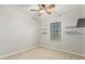 Bedroom has a window with blinds, neutral carpet, and small floating shelves at 1240 E Indigo St, Mesa, AZ 85203