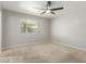 Neutral bedroom with a ceiling fan, carpet, and a bright window at 1240 E Indigo St, Mesa, AZ 85203