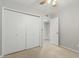 Simple bedroom with a ceiling fan and closet with sliding doors at 1240 E Indigo St, Mesa, AZ 85203