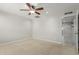 Bright bedroom featuring neutral paint, carpet flooring and an open doorway at 1240 E Indigo St, Mesa, AZ 85203