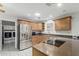Spacious kitchen boasts stainless steel appliances, countertop range, and adjacent laundry area at 1240 E Indigo St, Mesa, AZ 85203