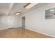 Basement living room with wood-look floors, a door, and bright lighting at 1240 E Indigo St, Mesa, AZ 85203