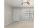 Inviting living room featuring neutral paint, carpet flooring and a front door view at 1240 E Indigo St, Mesa, AZ 85203