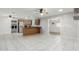 Open-concept living space featuring tile floors, kitchen island, and modern appliances at 1240 E Indigo St, Mesa, AZ 85203