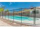 Sparkling pool is fenced for safety; lush landscaping is easy to maintain at 1240 E Indigo St, Mesa, AZ 85203