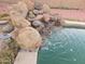 Backyard pool featuring a custom rock waterfall and beautiful water features at 1358 S Royal Palm Rd, Apache Junction, AZ 85119