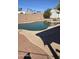 Inviting backyard pool with a large pool deck and privacy wall at 1358 S Royal Palm Rd, Apache Junction, AZ 85119