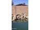 Backyard pool area with water feature set against a privacy wall at 1358 S Royal Palm Rd, Apache Junction, AZ 85119