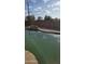 Backyard featuring a pool with a rock water feature surrounded by a block wall at 1358 S Royal Palm Rd, Apache Junction, AZ 85119