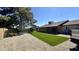 Expansive backyard with artificial turf, gravel, mature trees, and a view of the home's exterior at 14017 N 40Th Ave, Phoenix, AZ 85053